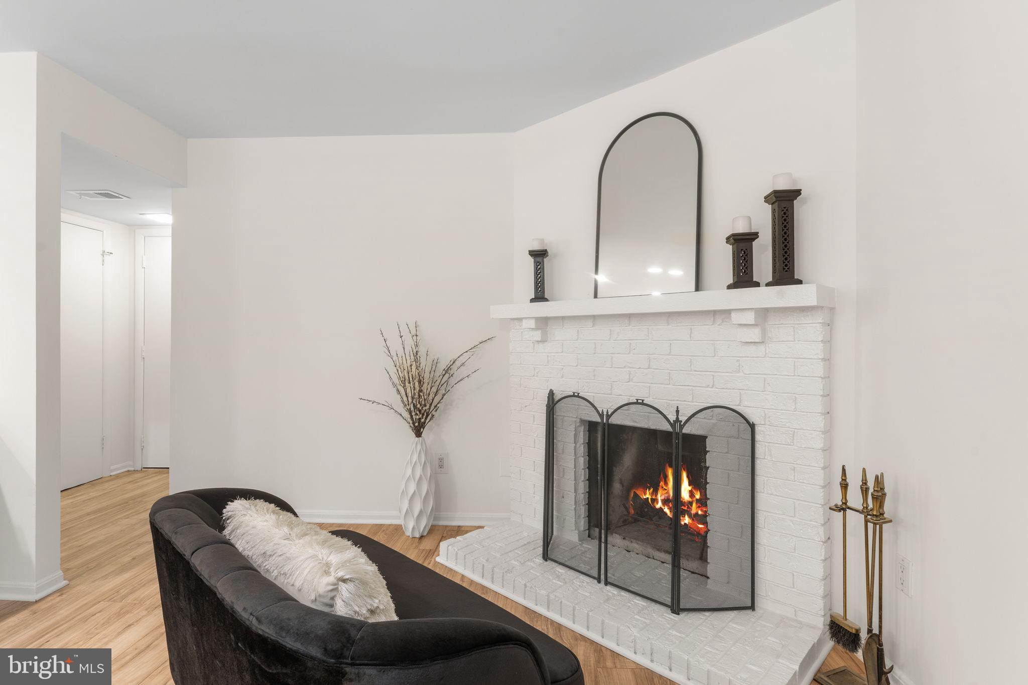 11401 Turnmill Lane Reston, VA 20191 - Photo 6 of 81 Cozy fireplace in a modern living space.