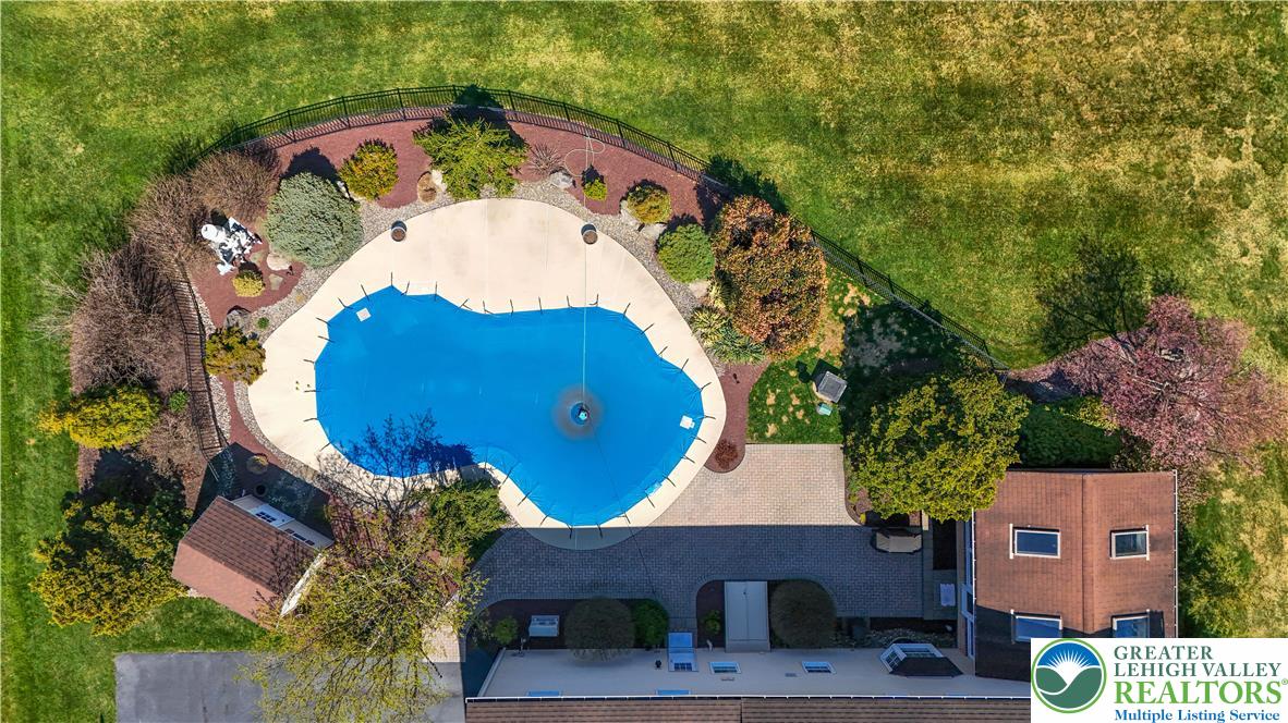 4059 Old Sentry Road Allentown, PA 18104 - Photo 39 of 39 An aerial perspective reveals a private, in-ground swimming pool nestled amidst lush landscaping, offering a tranquil escape.
