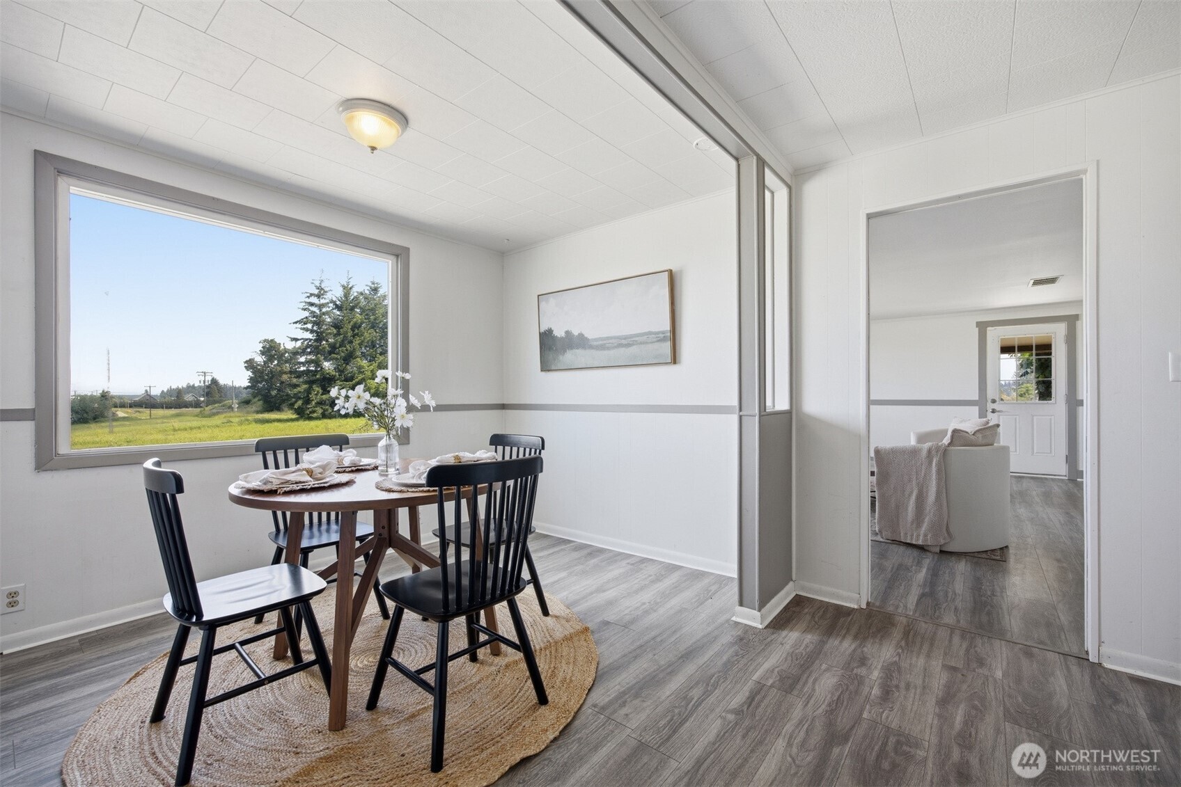 6791 Noon Road Everson, WA 98247 - Photo 16 of 38 a view of a dining room with furniture and a floor to ceiling window