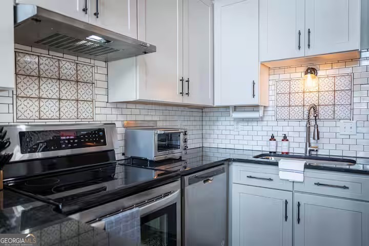 68 Franklin Road Eatonton, GA 31024 - Photo 14 of 28 a kitchen with stainless steel appliances a stove and a cabinets