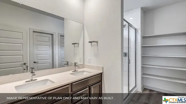 a bathroom with a sink double vanity and a mirror