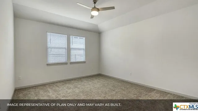 an empty room with a ceiling fan and window