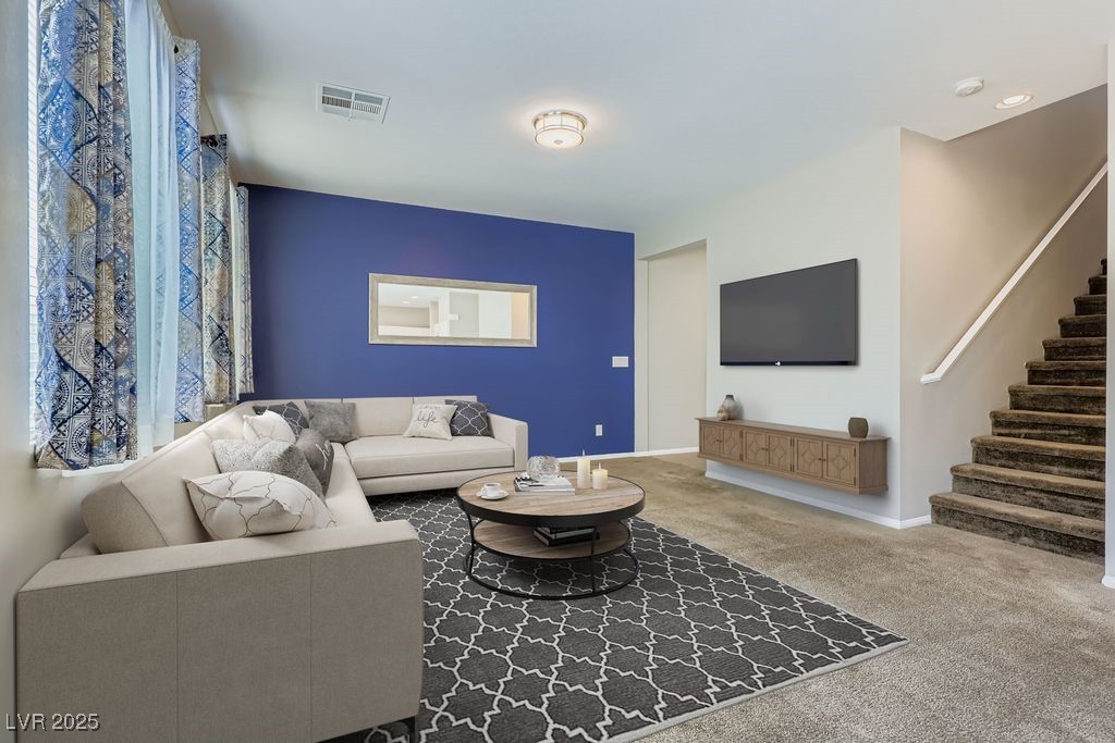(Virtually staged) Living room with stairway and carpet