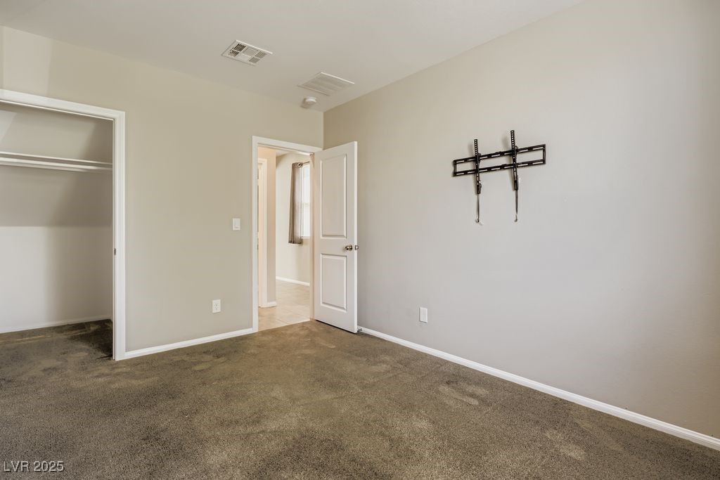 5712 Wishing Coin Court North Las Vegas, NV 89031 - Photo 13 of 24 Downstairs bedroom and a closet