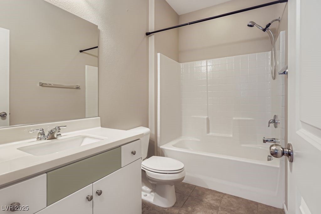 5712 Wishing Coin Court North Las Vegas, NV 89031 - Photo 15 of 24 Downstairs Full bathroom featuring bathing tub / shower combination, vanity, and light tile patterned floors