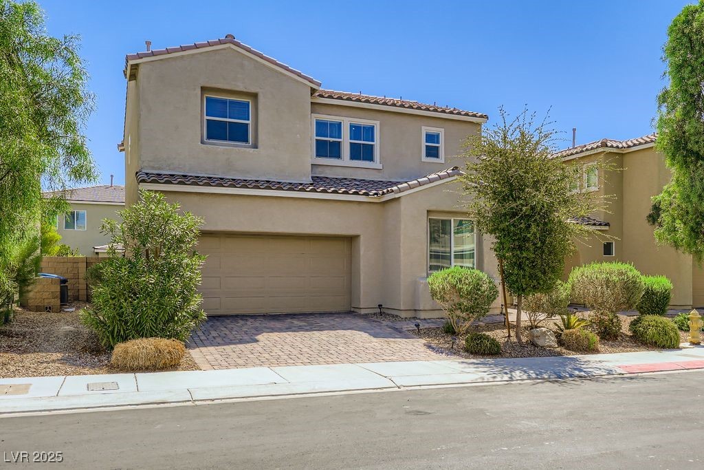 5712 Wishing Coin Court North Las Vegas, NV 89031 - Photo 2 of 24 Mediterranean / spanish-style house featuring a garage, stucco siding, decorative driveway, and a tiled roof