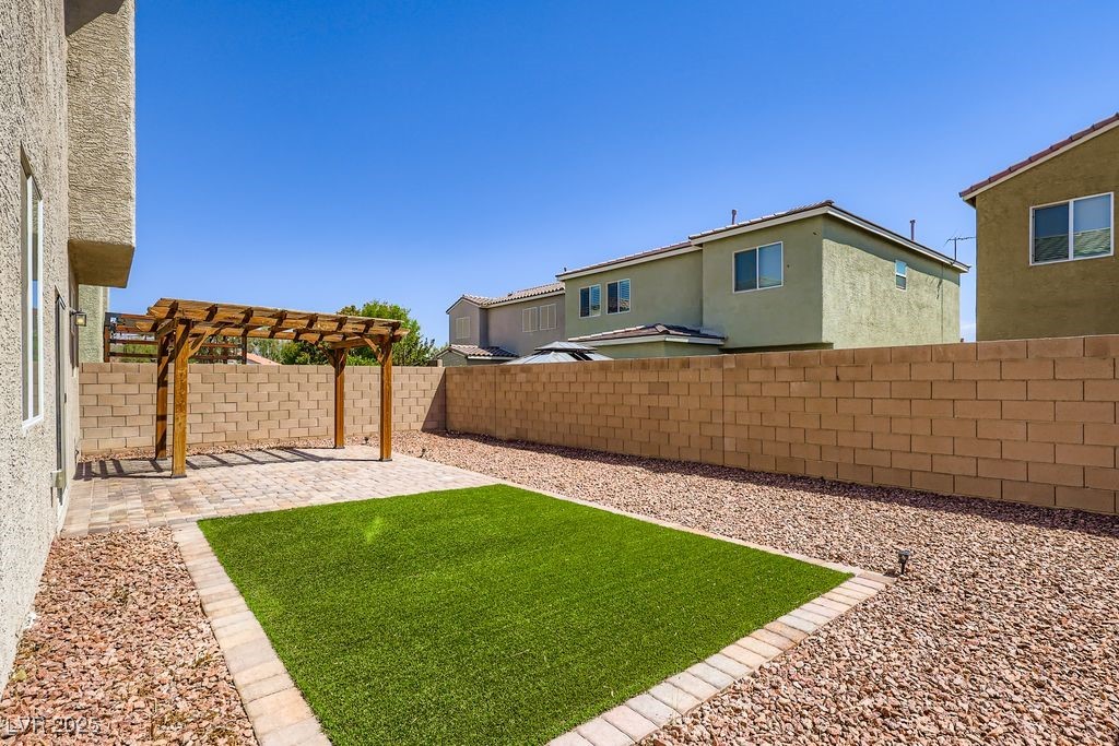 5712 Wishing Coin Court North Las Vegas, NV 89031 - Photo 24 of 24 Fenced backyard featuring a patio area and a pergola
