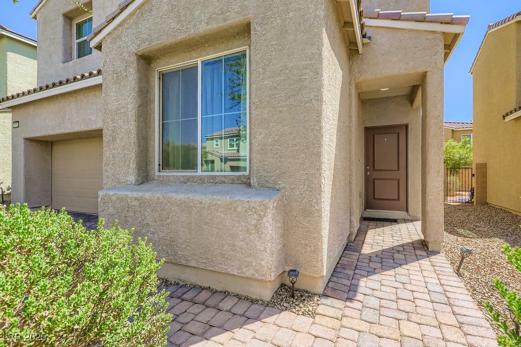 5712 Wishing Coin Court North Las Vegas, NV 89031 - Photo 3 of 24 Entrance to property featuring stucco siding