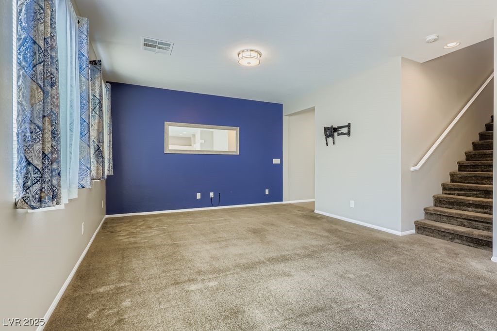 5712 Wishing Coin Court North Las Vegas, NV 89031 - Photo 4 of 24 Empty room featuring carpet and stairs