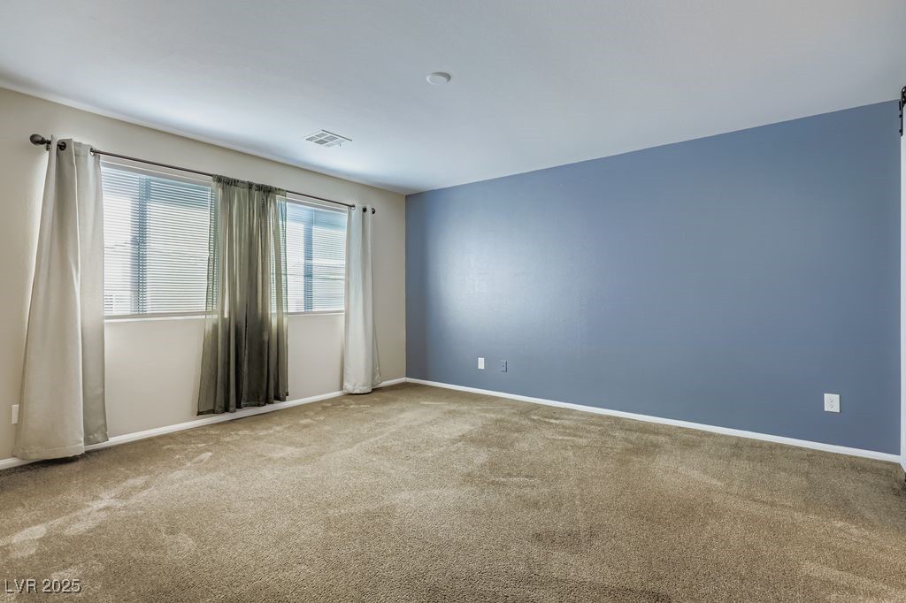5712 Wishing Coin Court North Las Vegas, NV 89031 - Photo 9 of 24 Carpeted empty room with baseboards
