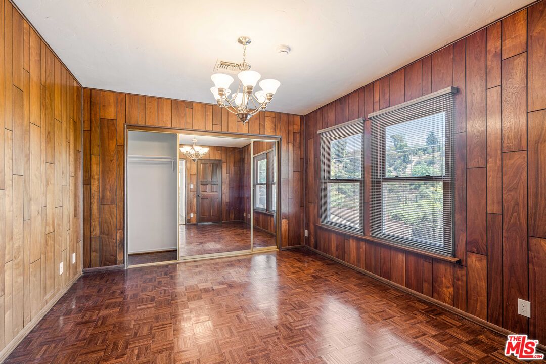 1181 Somera Road Los Angeles, CA 90077 - Photo 17 of 40 a view of a livingroom with a chandelier curtains and large windows
