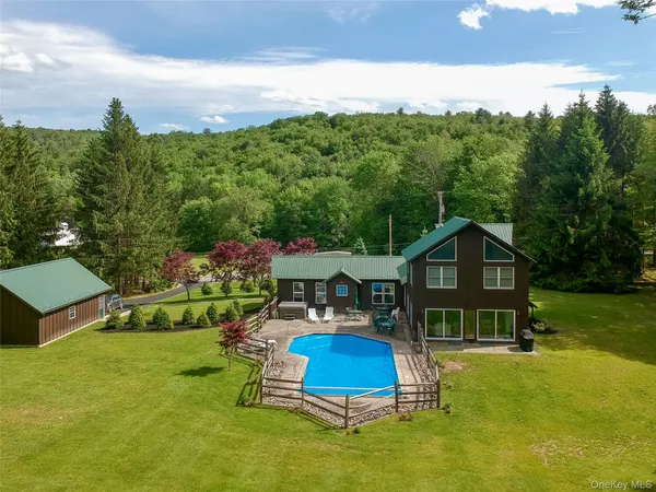 a view of a house with a yard balcony and a slide