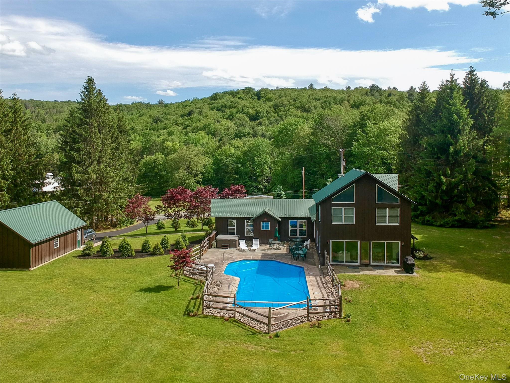 a view of a house with a yard balcony and a slide