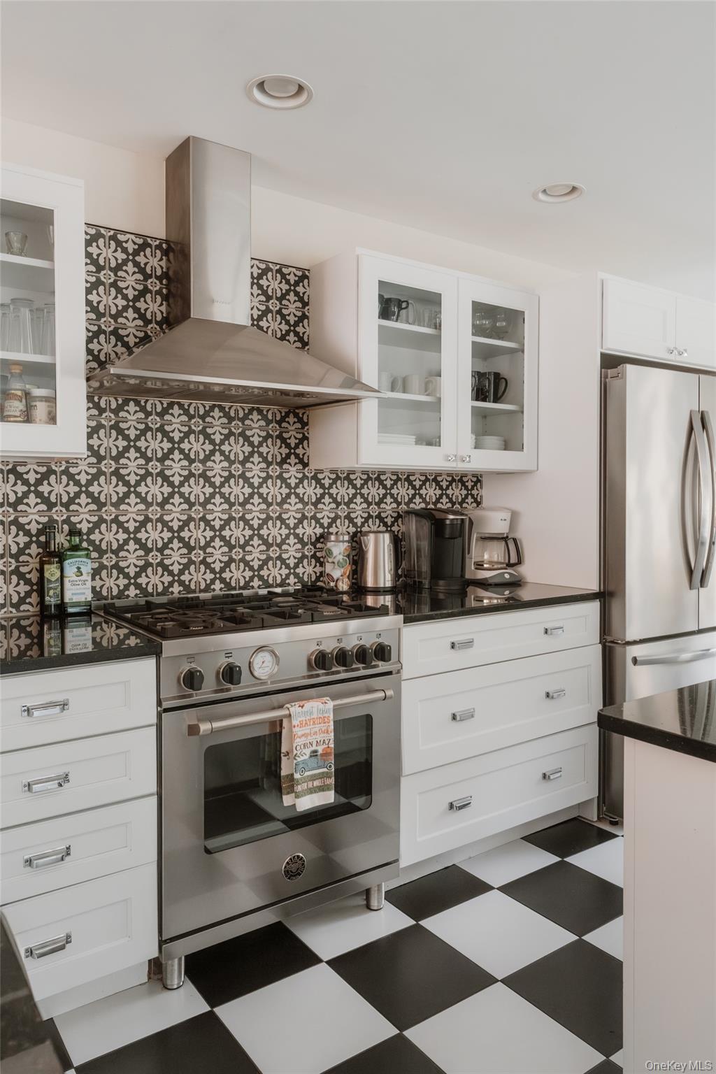 7775 State Rte 55 Neversink, NY 12765 - Photo 13 of 46 a kitchen with stainless steel appliances a stove and white cabinets