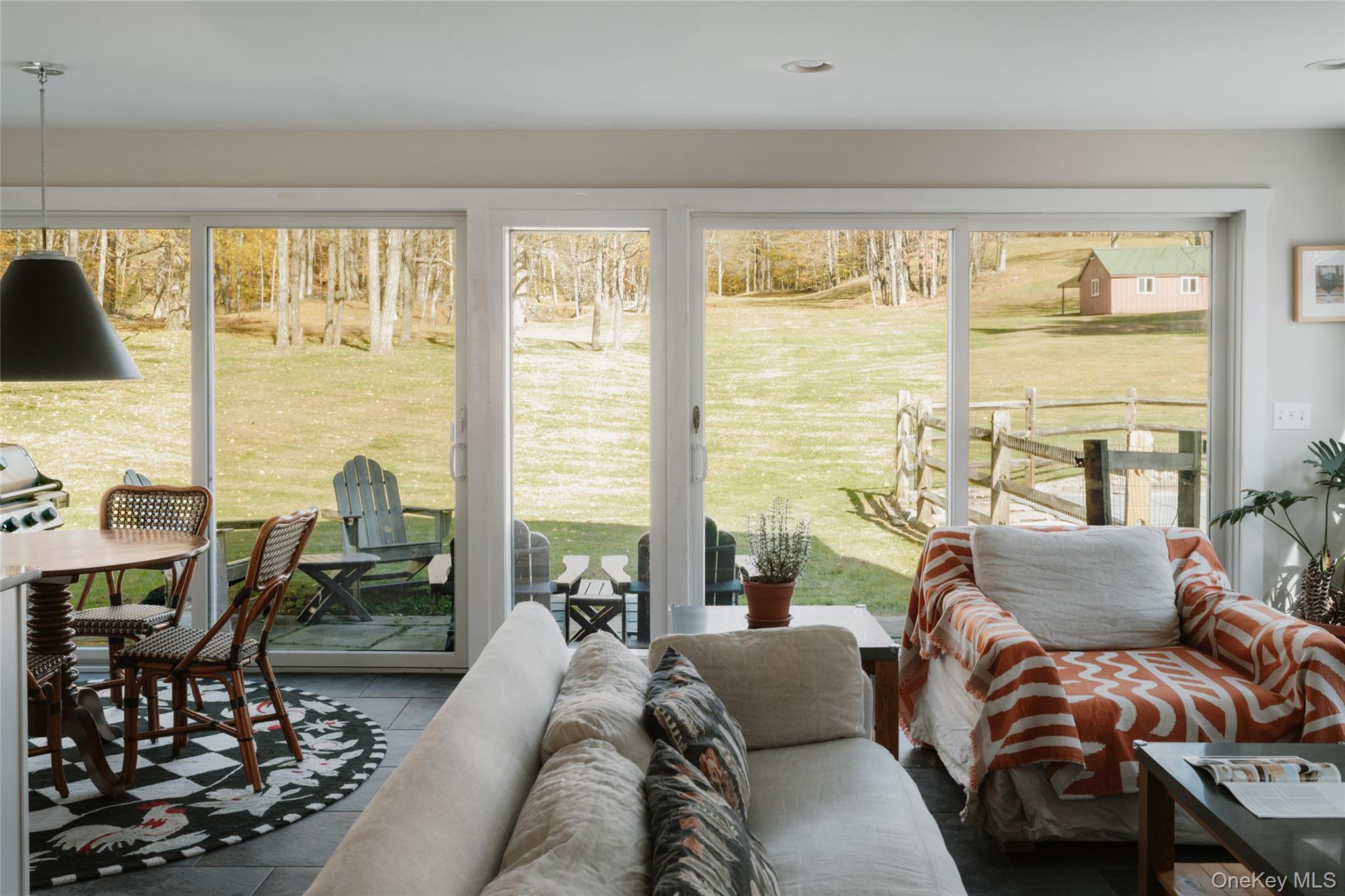 7775 State Rte 55 Neversink, NY 12765 - Photo 16 of 46 a living room with furniture and floor to ceiling windows