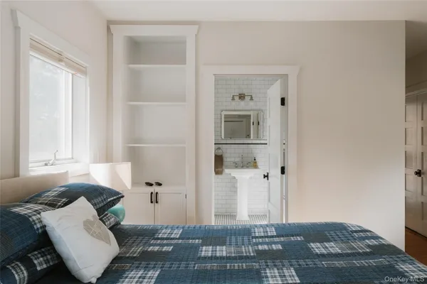 a bedroom with a bed and a window