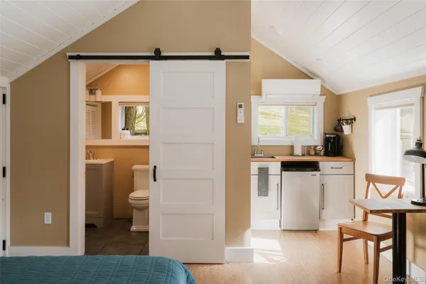 a kitchen with a refrigerator and white cabinets