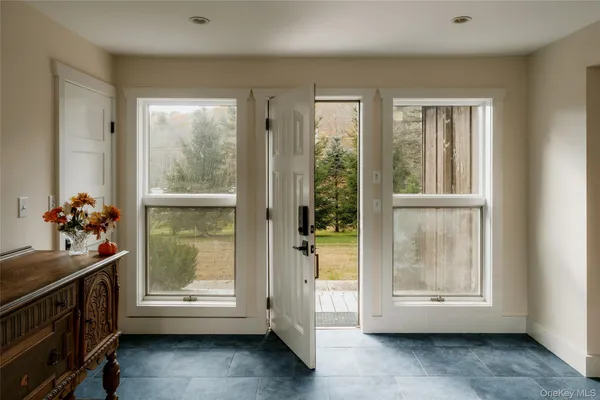 a room with a large window and a sink