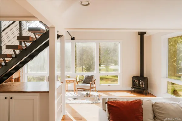 a living room with hardwood floor and a large window