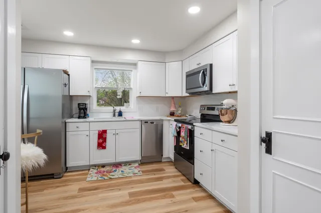 a kitchen with stainless steel appliances granite countertop a refrigerator sink and microwave