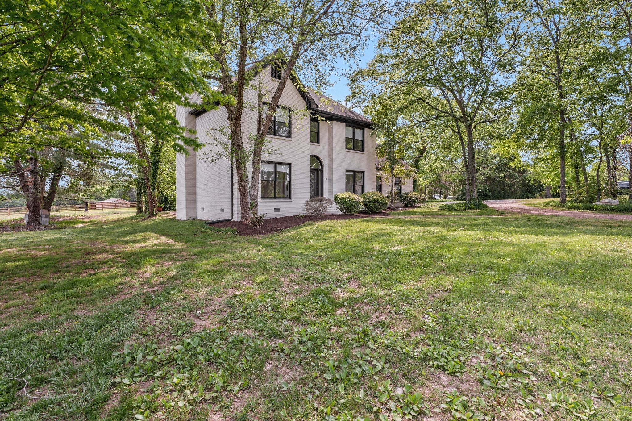 4519 Murfreesboro Road Franklin, TN 37067 - Photo 5 of 51 a view of a house with a big yard and large trees