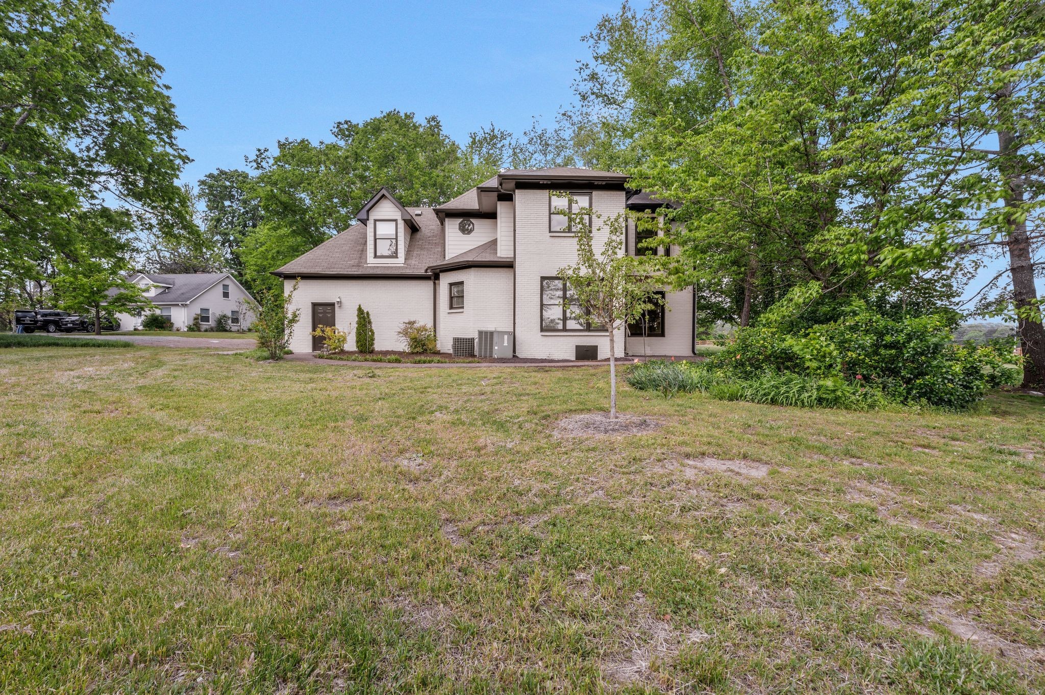 4519 Murfreesboro Road Franklin, TN 37067 - Photo 7 of 51 a view of a house with a big yard and large trees