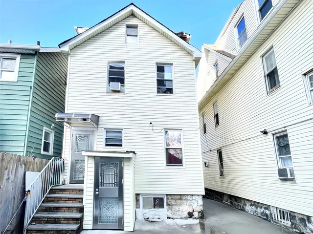 a view of a white house with many windows