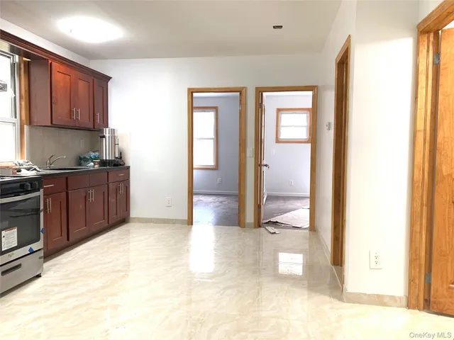 a view of a kitchen with a sink and cabinets