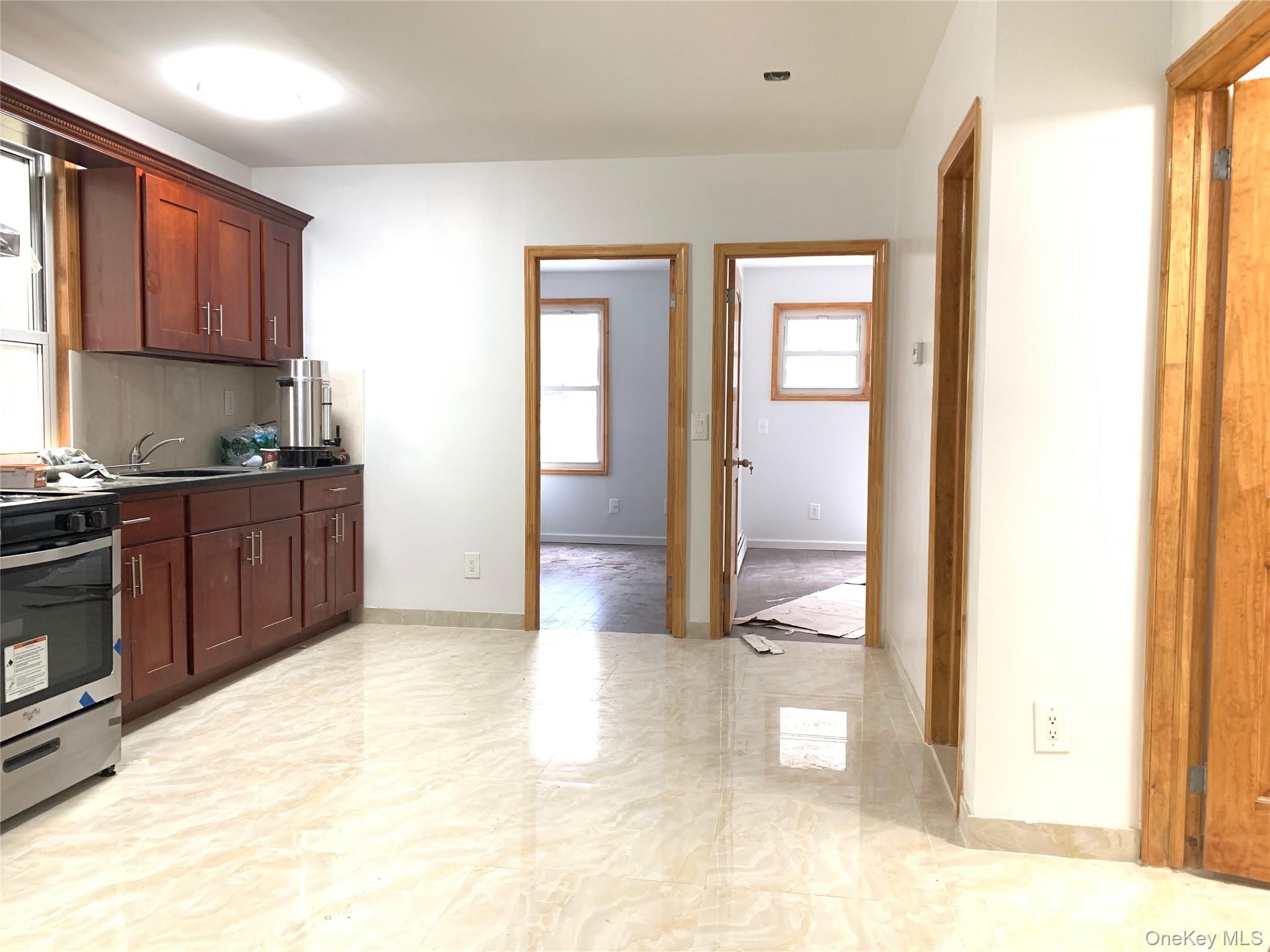 83-08 Pettit Avenue Queens, NY 11373 - Photo 5 of 6 Kitchen with stainless steel gas range oven, dark countertops, and backsplash