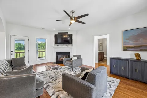 a living room with furniture a fireplace and a flat screen tv