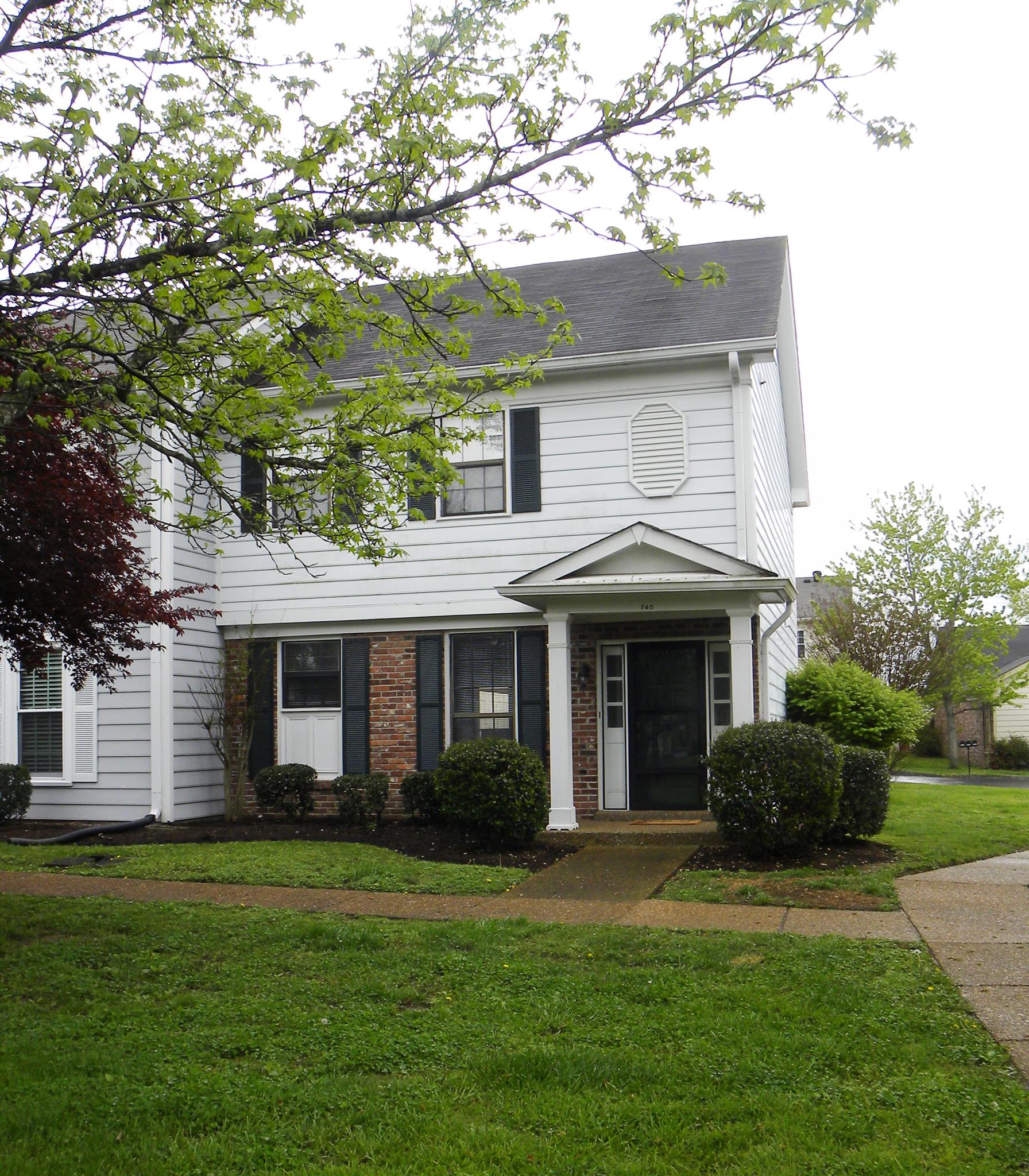 745 General George Patton Road Nashville, TN 37221 - Photo 1 of 12 a front view of a house with a garden
