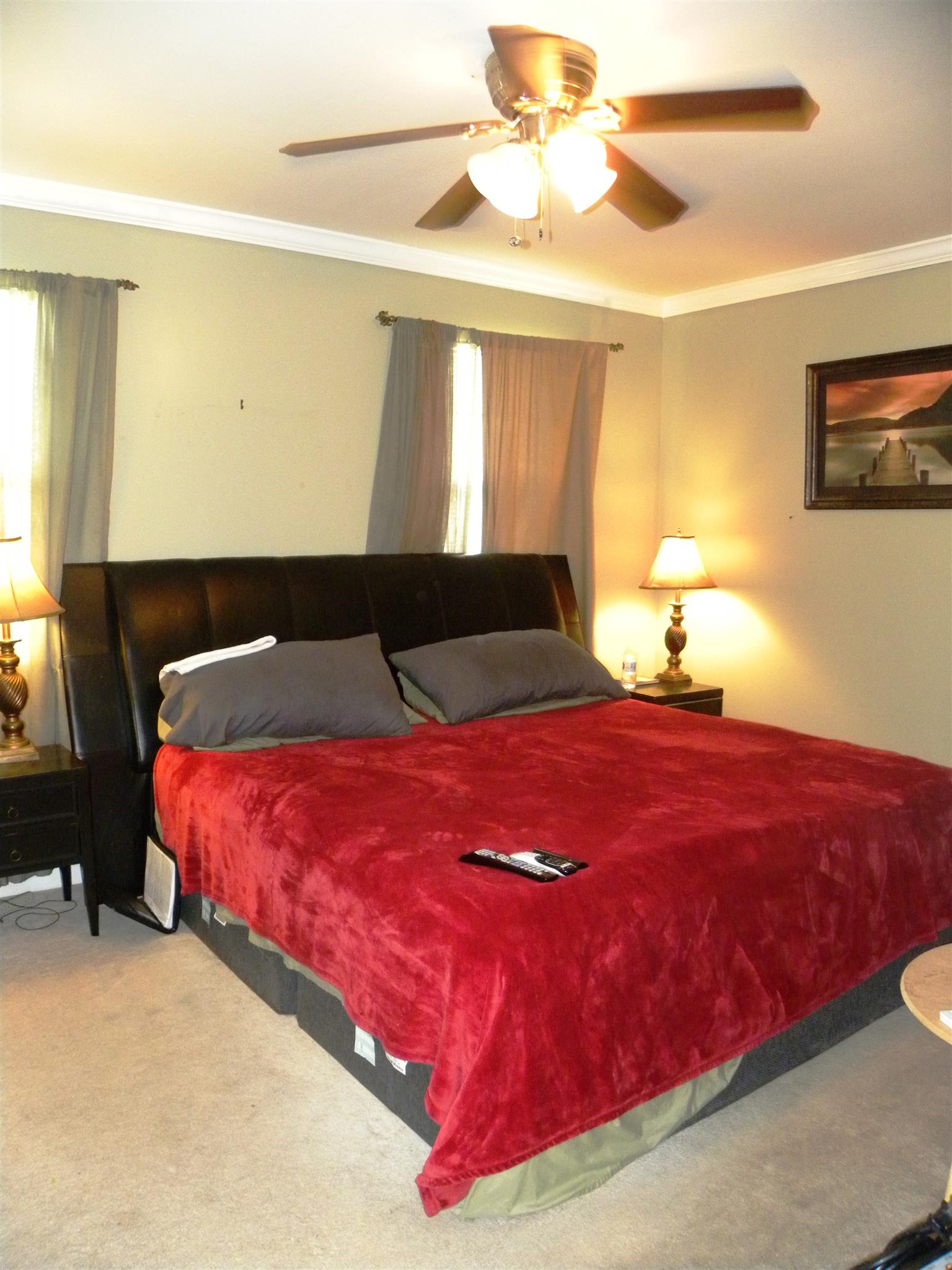 745 General George Patton Road Nashville, TN 37221 - Photo 8 of 12 a bedroom with a bed and a chandelier