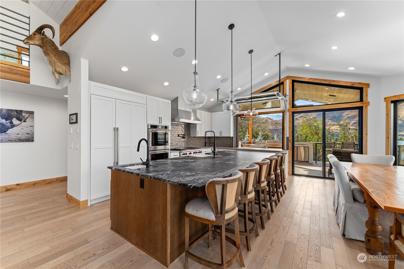 225 Turtle Rock Road East Wenatchee, WA 98802 - Photo 15 of 40 a kitchen with stainless steel appliances granite countertop table chairs stove and wooden floor