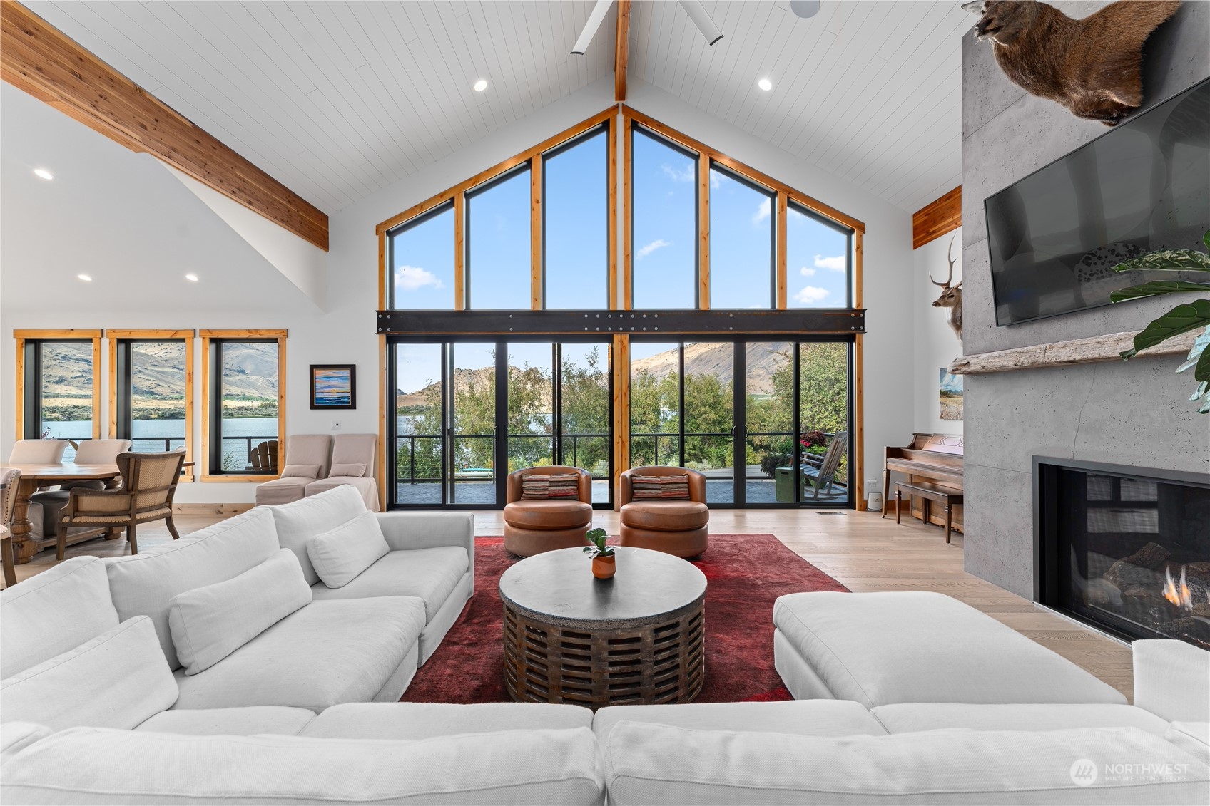 225 Turtle Rock Road East Wenatchee, WA 98802 - Photo 18 of 40 a living room with furniture a large window and a fireplace