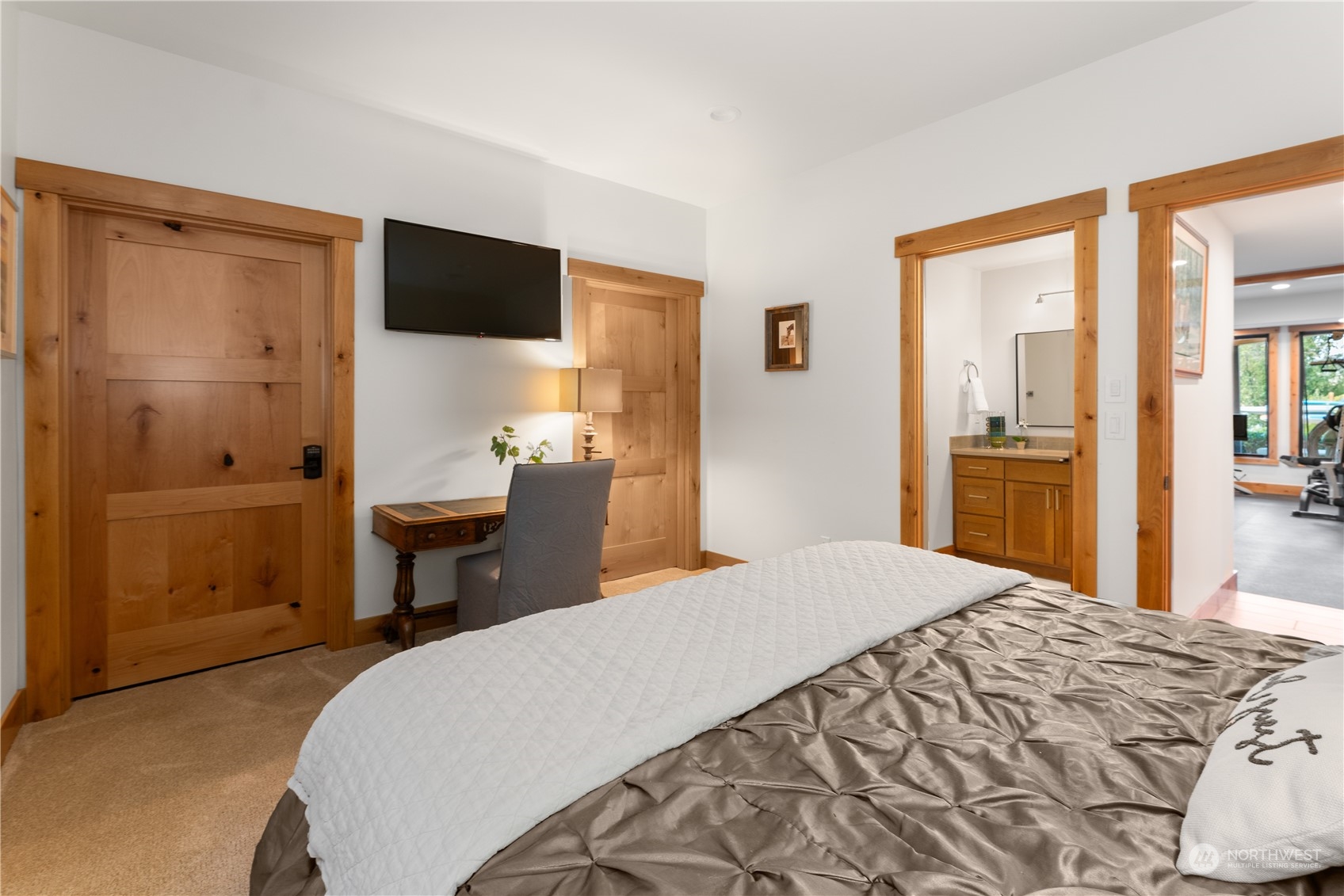 225 Turtle Rock Road East Wenatchee, WA 98802 - Photo 35 of 40 a bedroom with a bed and a flat tv screen next to a window