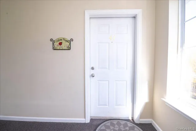 a view of a hallway with wooden floor and closet