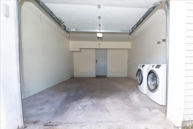 a view of a storage & utility room with dryer and washer