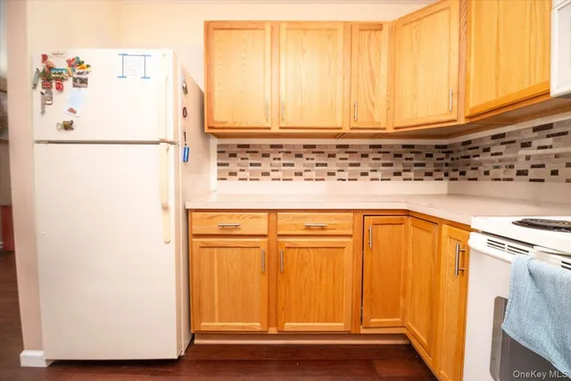a white refrigerator freezer sitting in a kitchen