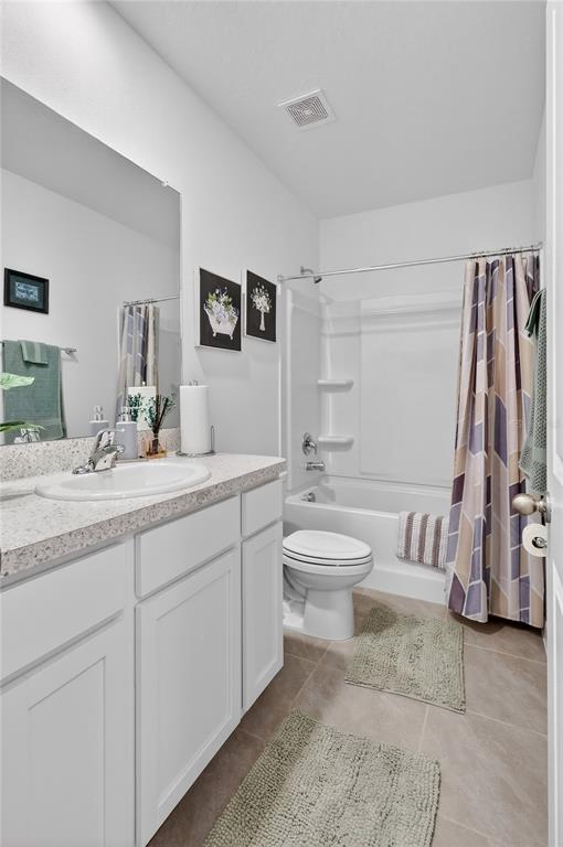 16632 Grotto Steam Place Wimauma, FL 33598 - Photo 24 of 42 a bathroom with a double vanity sink a toilet a mirror and shower