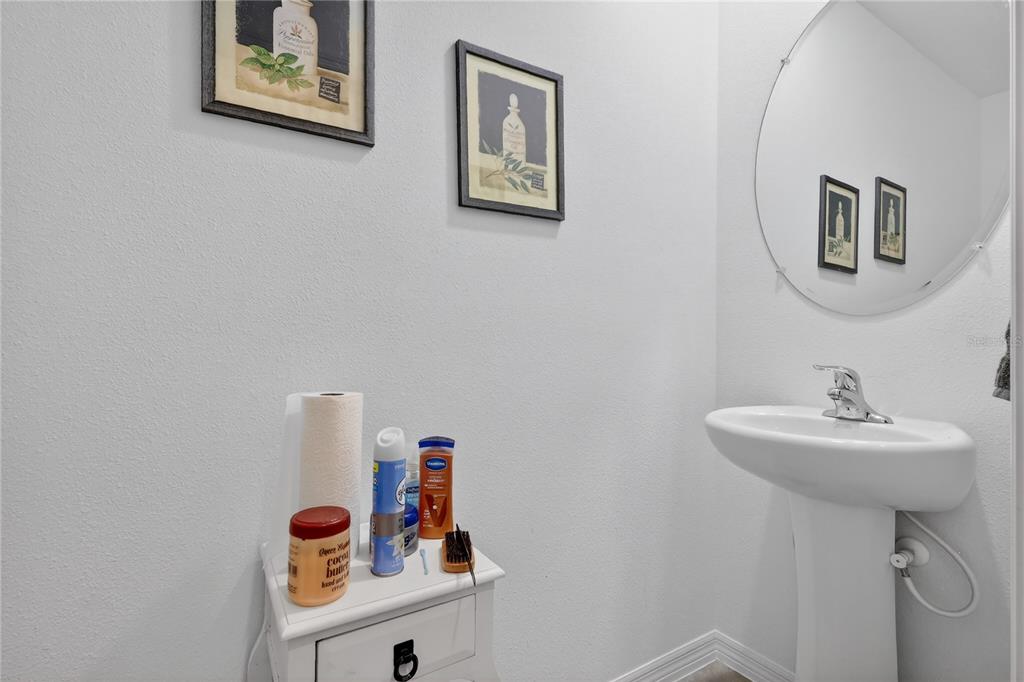 16632 Grotto Steam Place Wimauma, FL 33598 - Photo 28 of 42 a bathroom with a sink and a mirror