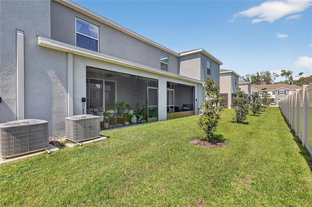 16632 Grotto Steam Place Wimauma, FL 33598 - Photo 29 of 42 a view of a house with a yard and plants