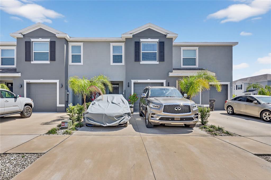 16632 Grotto Steam Place Wimauma, FL 33598 - Photo 38 of 42 a car parked in front of a house