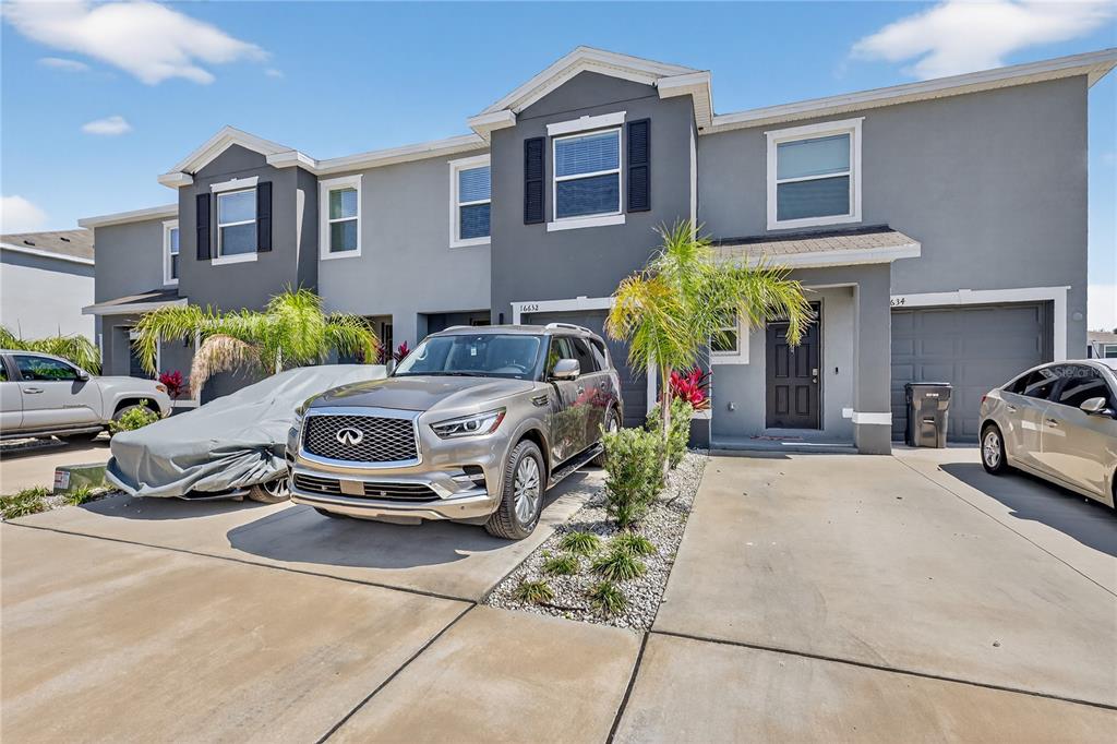 16632 Grotto Steam Place Wimauma, FL 33598 - Photo 4 of 42 a car parked in front of a brick house