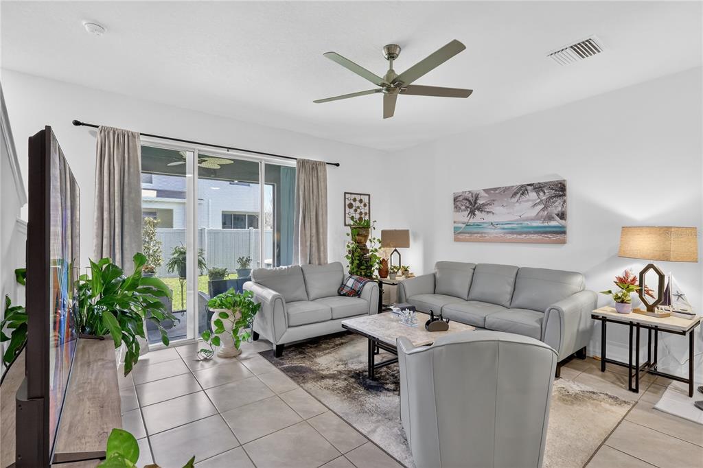 16632 Grotto Steam Place Wimauma, FL 33598 - Photo 7 of 42 a living room with furniture and a large window