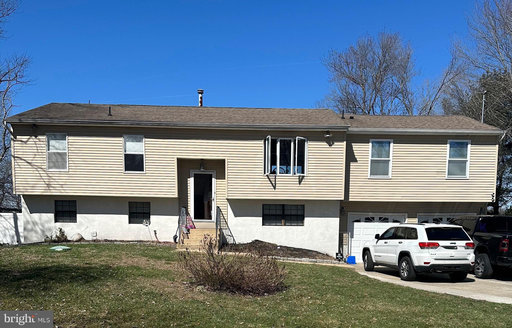a car parked in front of a white house