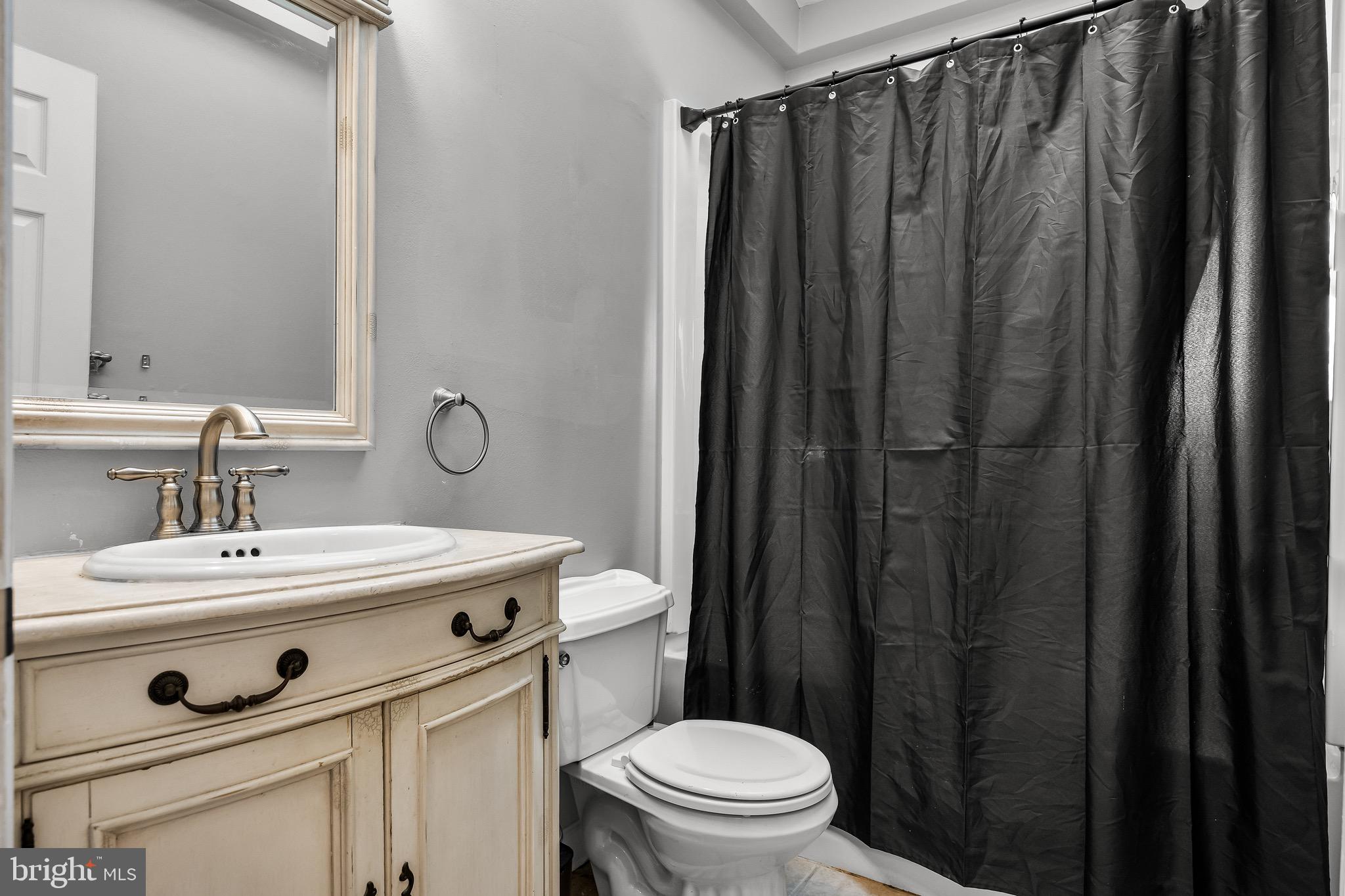 293 Waterford-Blue Anchor Road Hammonton, NJ 08037 - Photo 15 of 24 a bathroom with a sink a toilet a mirror and shower curtain