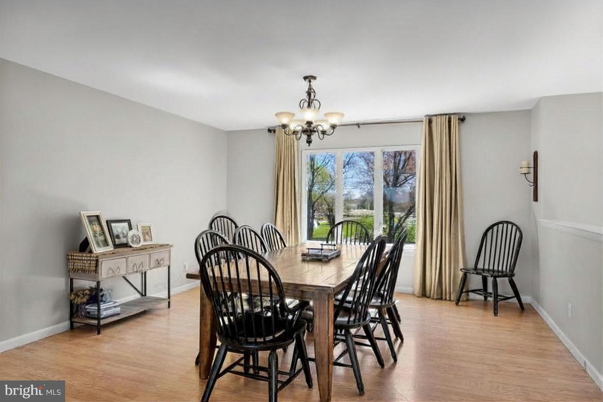 293 Waterford-Blue Anchor Road Hammonton, NJ 08037 - Photo 10 of 24 a view of a dining room with furniture a chandelier and wooden floor