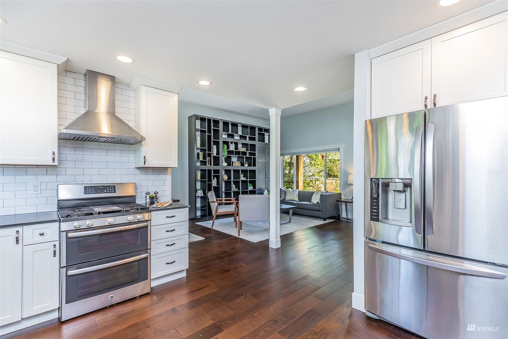 22110 14th Avenue West Bothell, WA 98021 - Photo 11 of 40 a kitchen with stainless steel appliances a refrigerator and a wooden floor