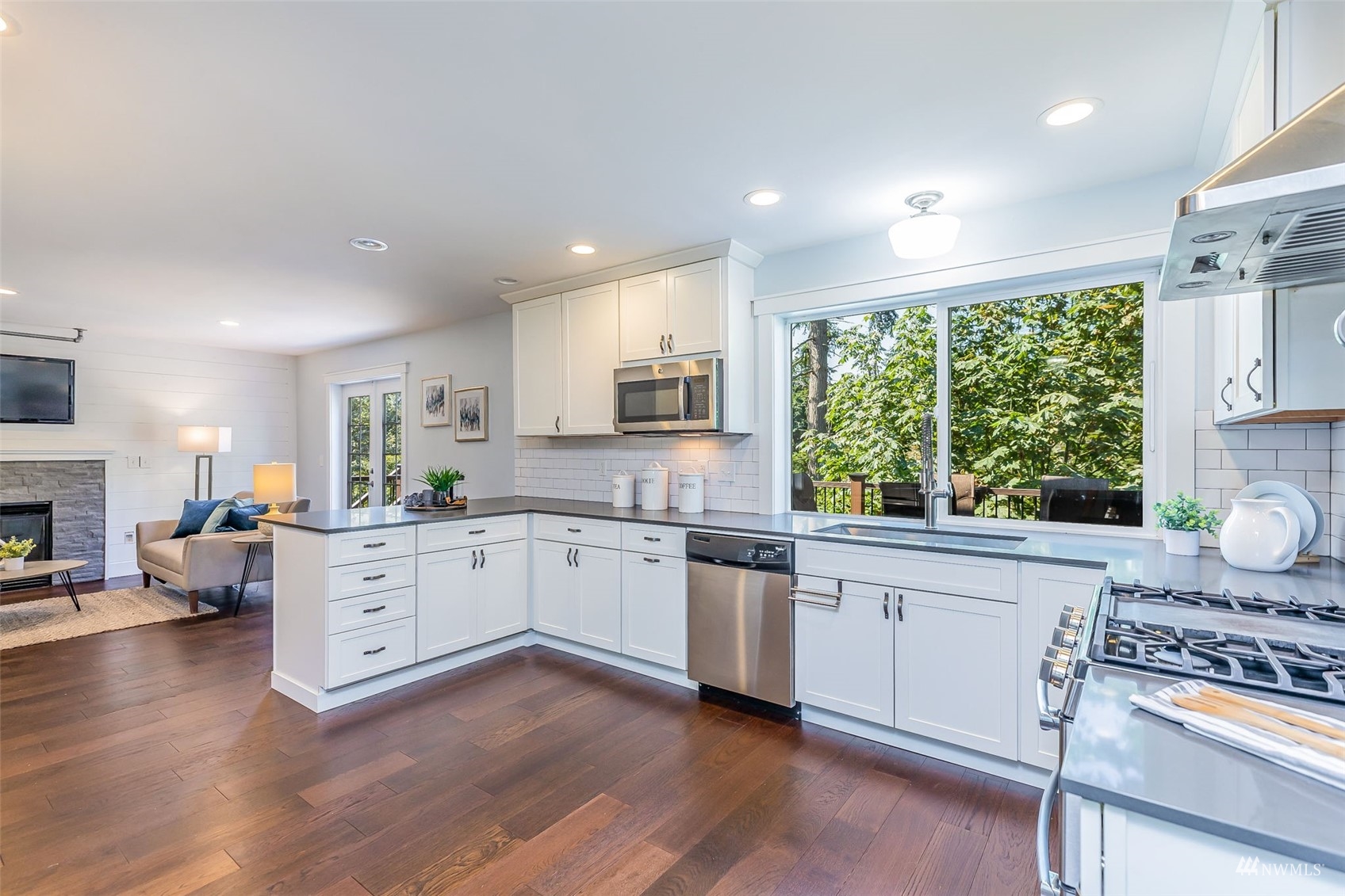 22110 14th Avenue West Bothell, WA 98021 - Photo 12 of 40 a kitchen with granite countertop white cabinets and white appliances