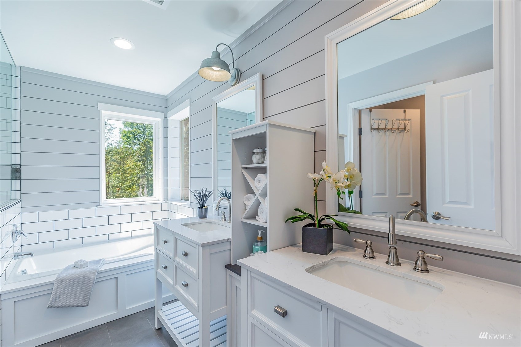 22110 14th Avenue West Bothell, WA 98021 - Photo 31 of 40 a bathroom with a double vanity sink a mirror and a bathtub